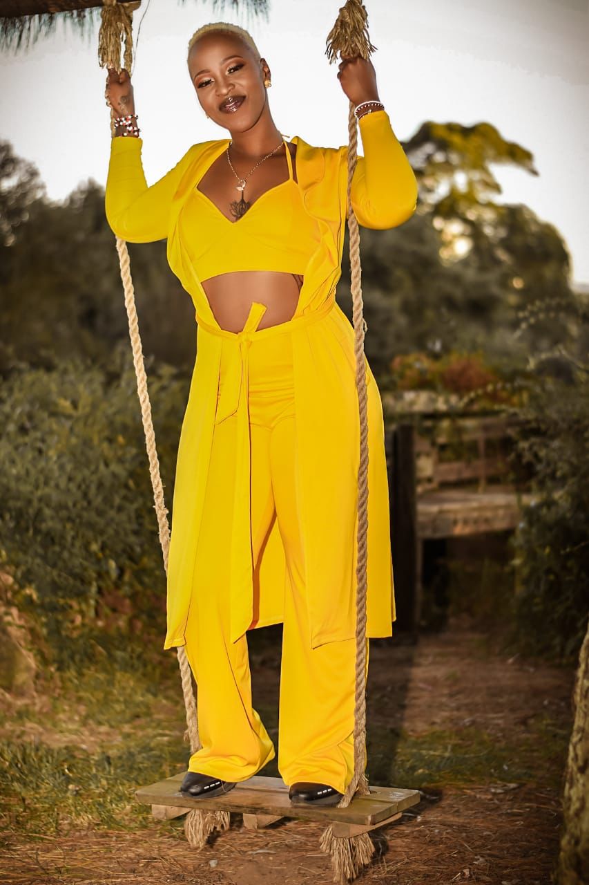 Mizz Gabbzz on swing in yellow outfit